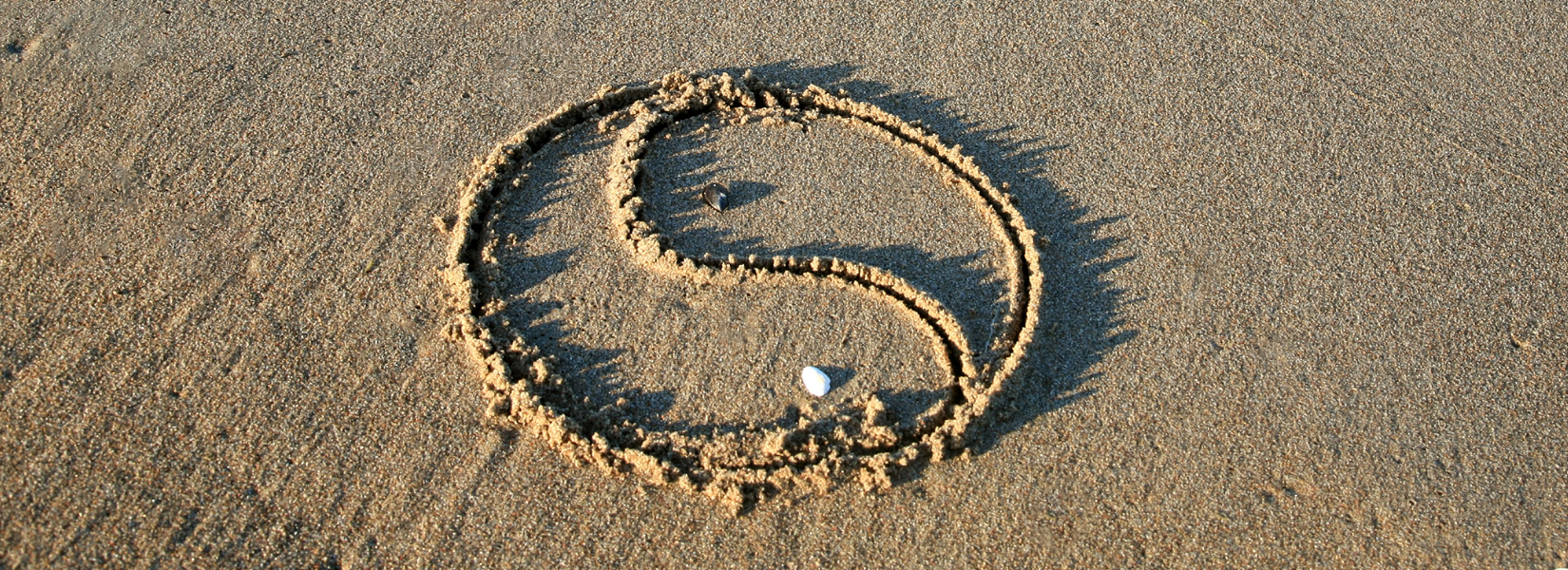 Yin Yang symbol drawn in sand